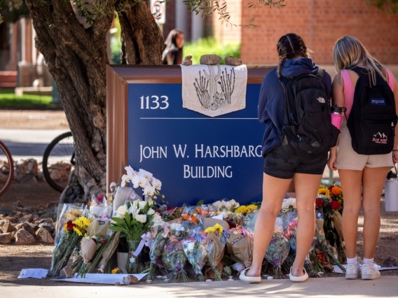 Students visit a makeshift memorial outside the John W. Harshbarger Building.
