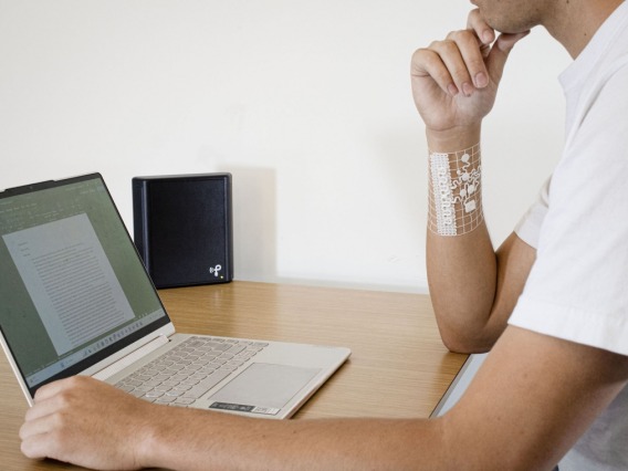 Man wearing wearable device for health at desk