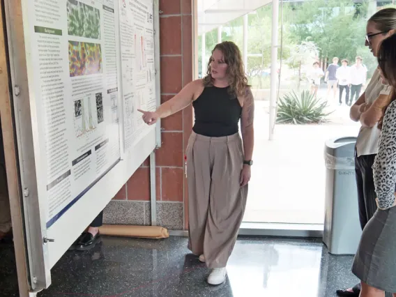 Woman presenting poster at the BIO5 Institute